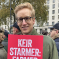 James holds placard at protest